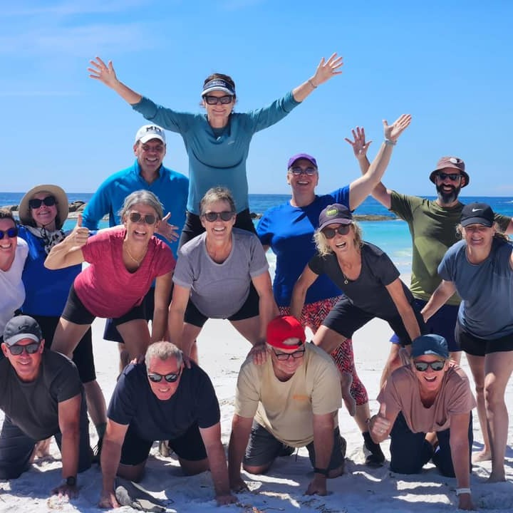 Group of people posing on beach