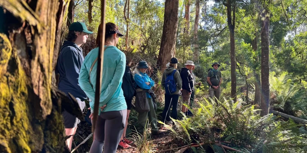 A group of hikers in Lerderderg Gorge in Victoria listening to their hiking guide