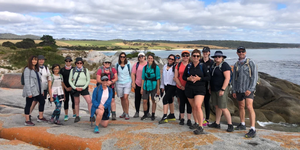 3 Best Hikes in Tasmania for Every Skill Level 1 A group of hikers at the Bay of Fires, a beginner-friendly hiking location in Tasmania