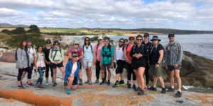 3 Best Hikes in Tasmania for Every Skill Level 2 A group of hikers at the Bay of Fires, a beginner-friendly hiking location in Tasmania